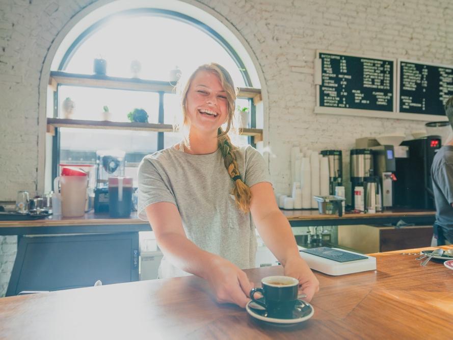 Coffee shop owner serving coffee